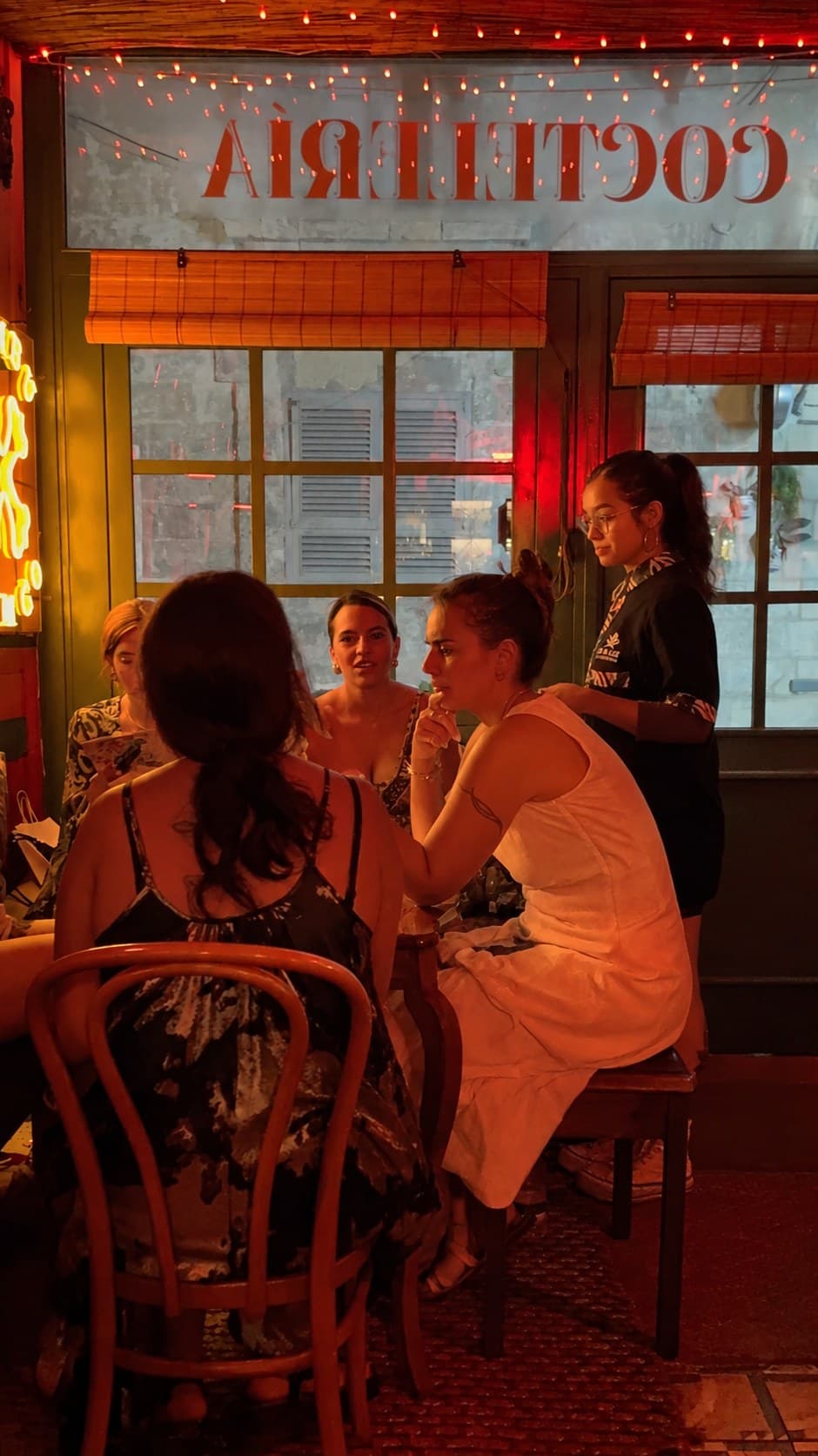 Guests under the Coctelería sign